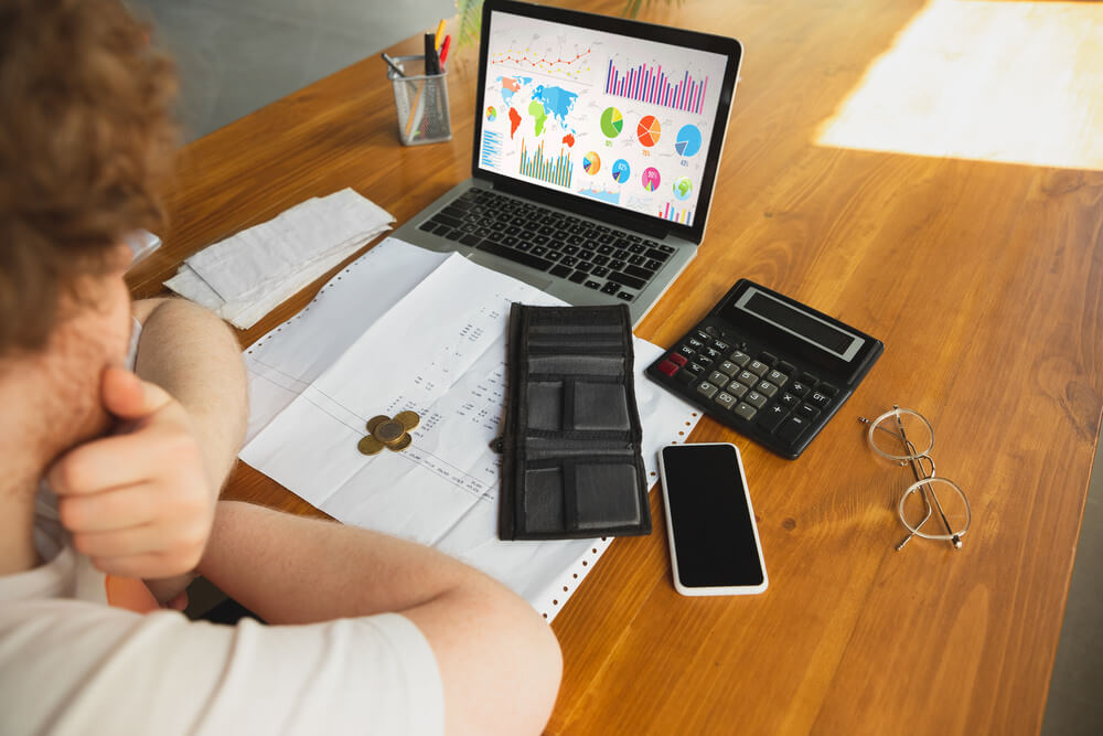 Person analyzing costs and margins data at the desk