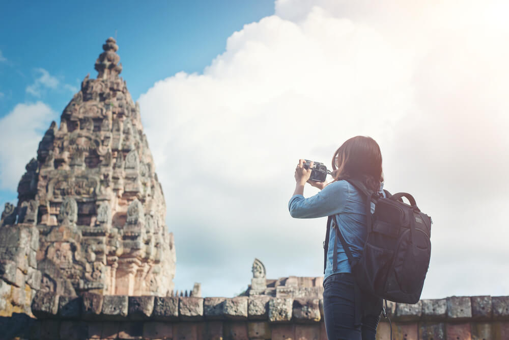 Solo traveler exploring an ancient temple on a cultural tour