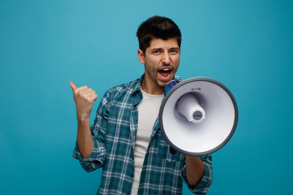 Person with megaphone representing upsells